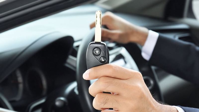 Holding car key featuring car rental facility at Luxury Suites Amsterdam