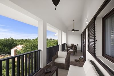 A balcony lounge area with forest view at Club Hemingway