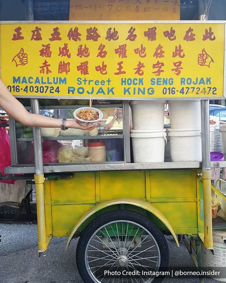 a person holding rojak in front of Hock Seng Rojak stall at Macallum Street Penang
