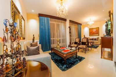 Luxury lobby lounge area with cozy sofas & chandeliers at Le Manoir Bogotá Hotel