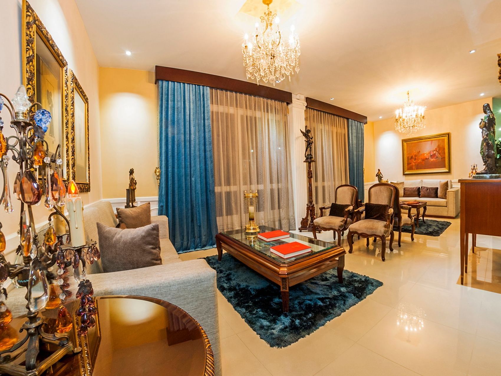 Luxury lobby lounge area with cozy sofas & chandeliers at Le Manoir Bogotá Hotel