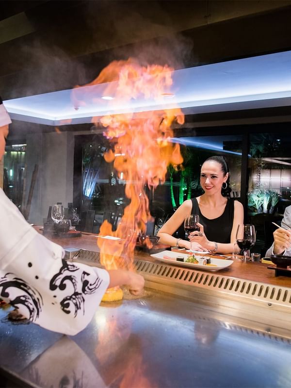 Couple enjoying Teppanyaki grill at Enotel Hotels & Resorts