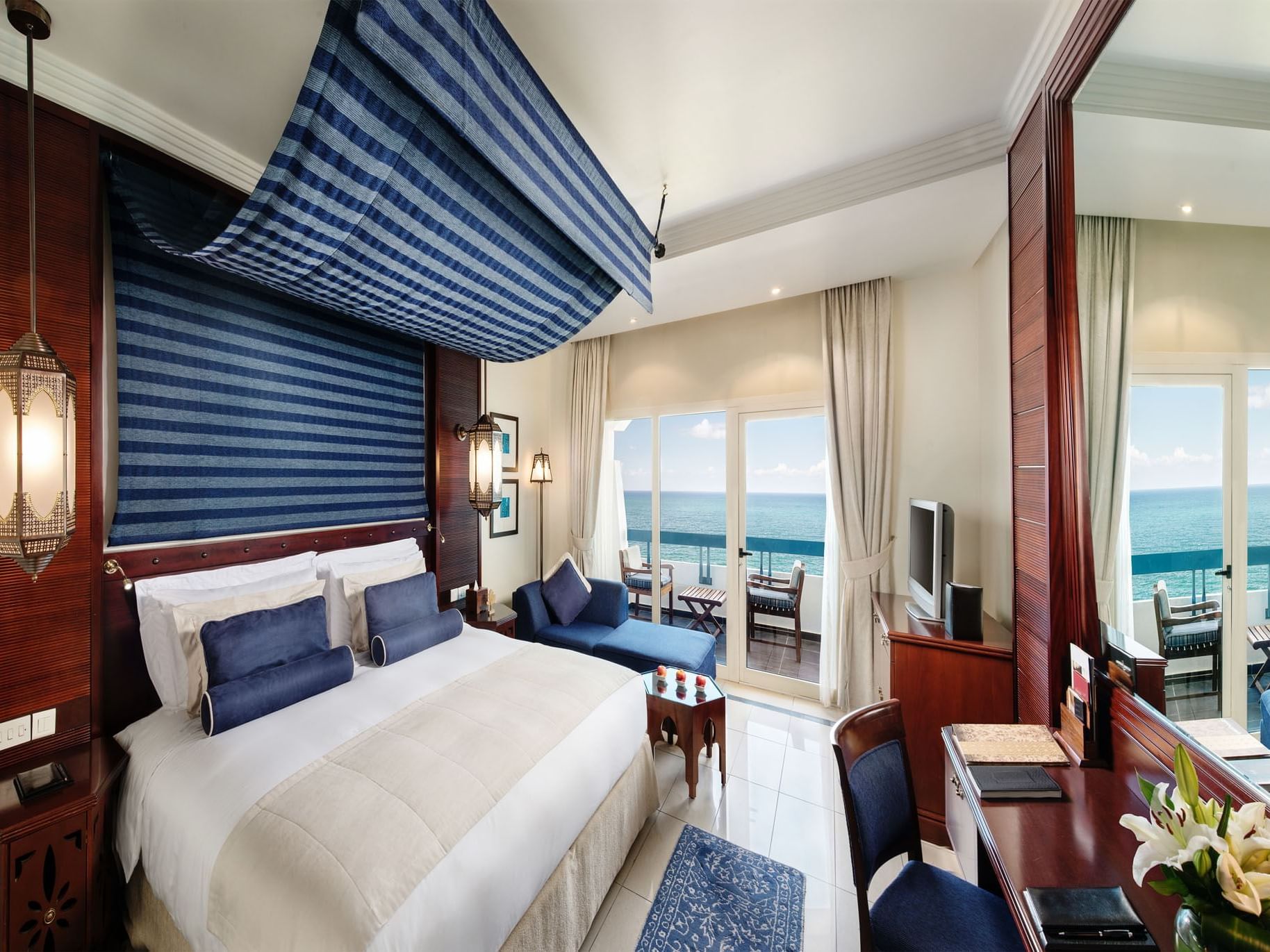 King bed in Sea view signature deluxe room at Ajman Hotel