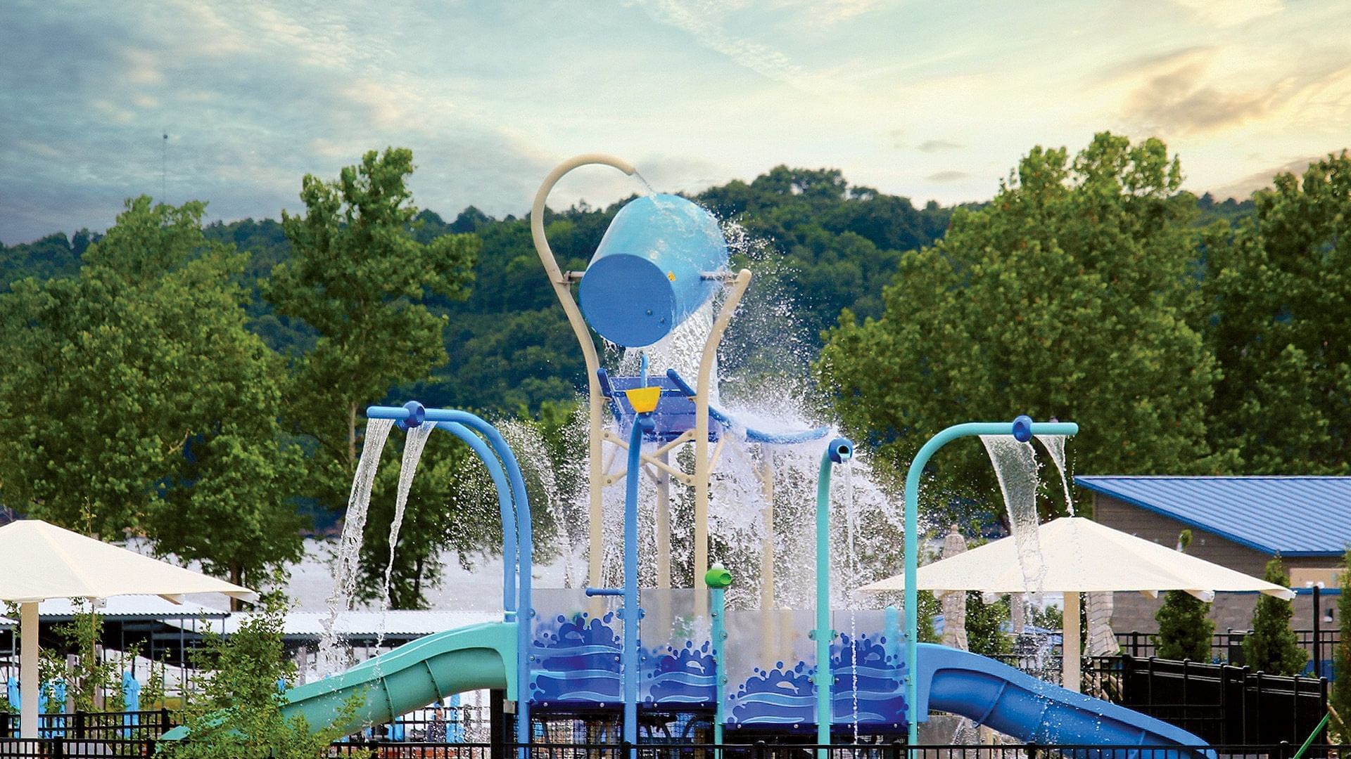Colorful children's water park featuring a tipping bucket and small blue slides at Shangri-La Resort and Golf Club