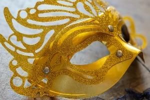 A yellow and gold Mardi Gras mask.