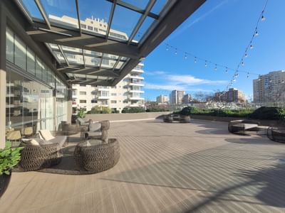 Rooftop terrace featuring outdoor lounge seating and string lighting under a glass canopy in Mistral 3-4 at Veranda Hotel