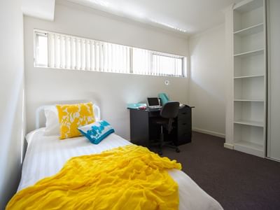 Student Living Edge Apartments – Grote Street Building - Typical bedroom with single bed, study desk & chair & built in wardrobe