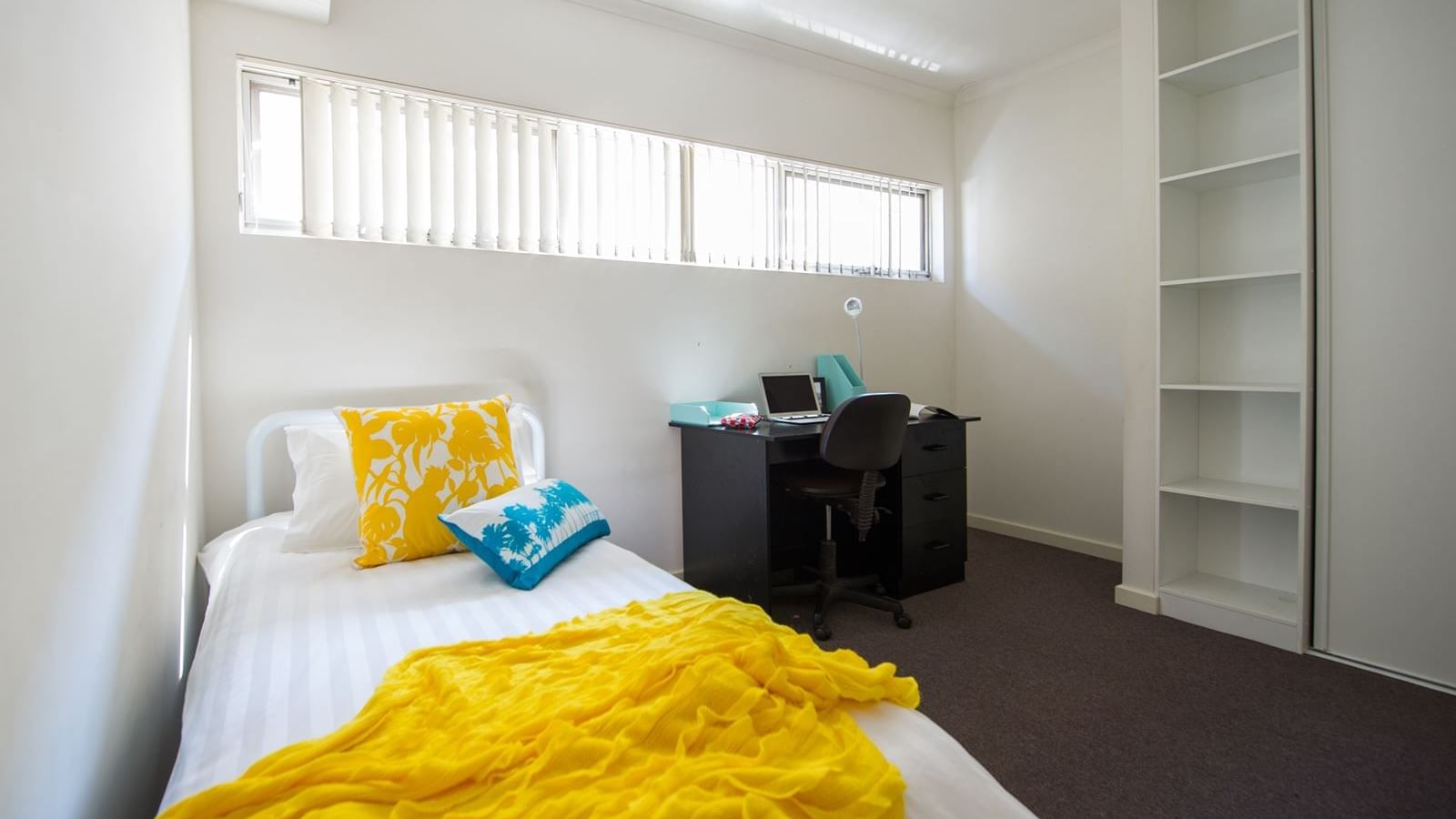 Student Living Edge Apartments – Grote Street Building - Typical bedroom with single bed, study desk & chair & built in wardrobe