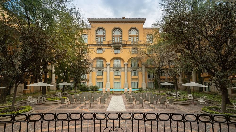 Jardin Plaza Magnolias wedding setup featuring a stone courtyard with trees at Quinta Real Monterrey