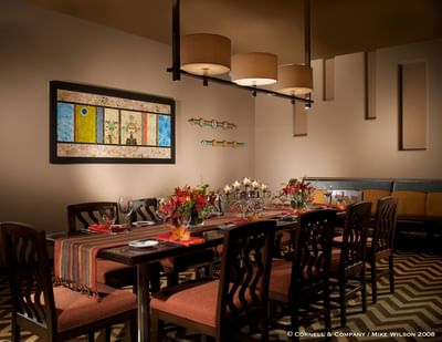 Elegant dining area at Hilton Santa Fe Buffalo Thunder, adorned with Native American art and candlelight ambiance