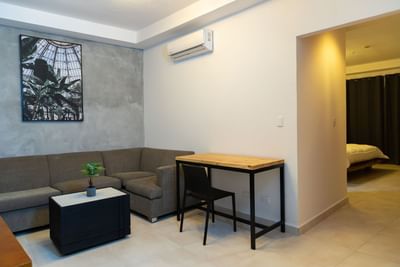 Seating area with workspace and entrance to the room at Panama hotel