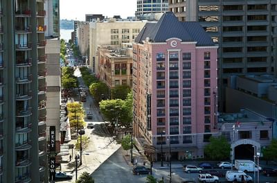 Aerial View of The Paramount Hotel Seattle with a pink facade and a view of the city street and other buildings