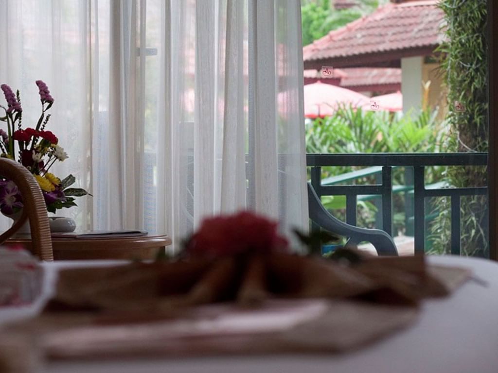 Bed with garden view in Andaman Suite at Amora Hotel