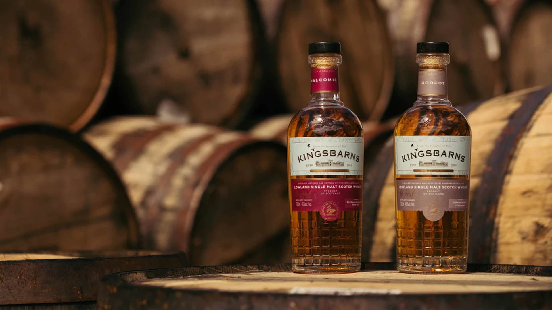 Two bottles of Kingsbarns single malt Scotch whisky in front of wooden barrels at Seaton House