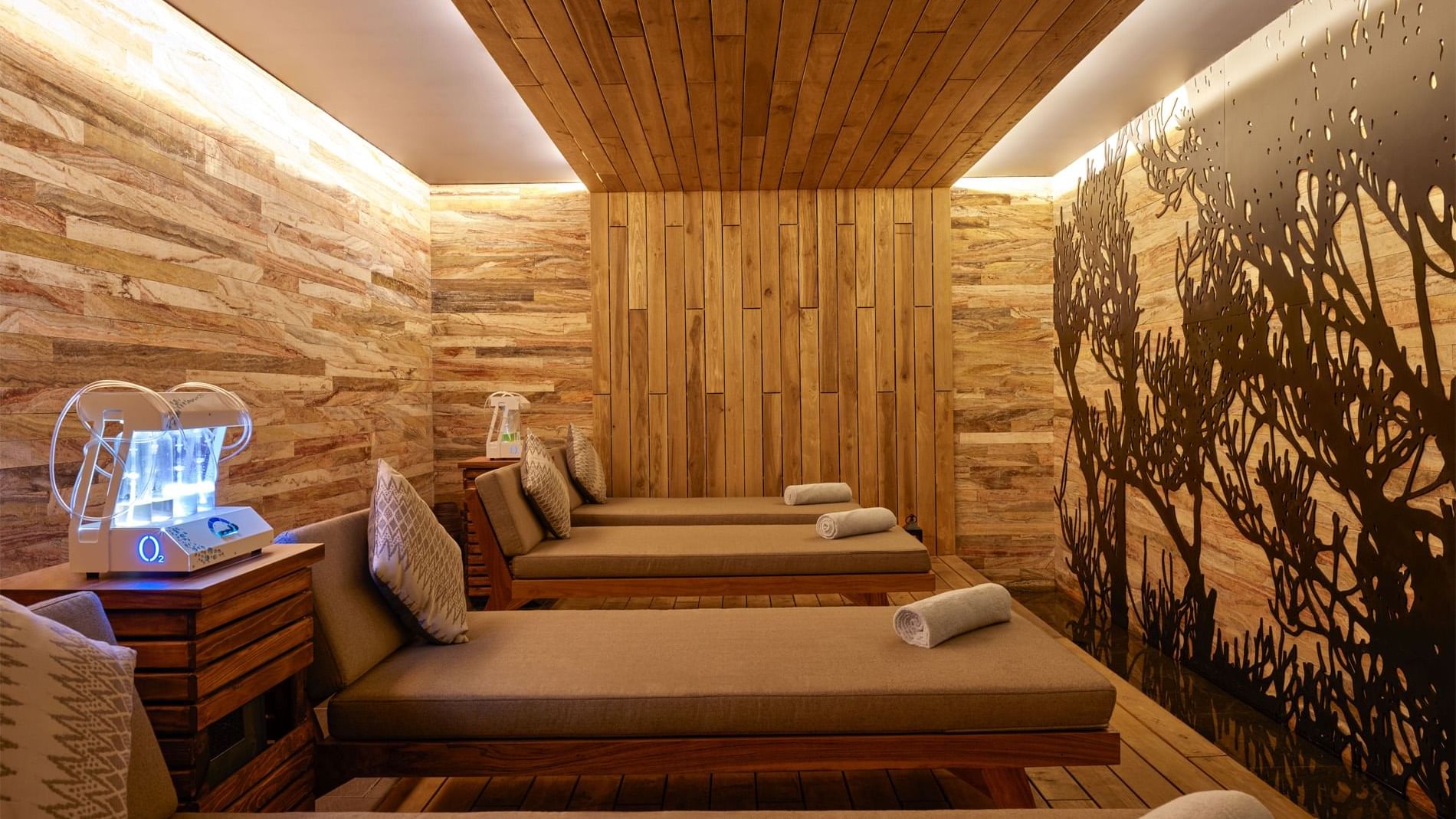 Interior of hotel spa with wooden walls & beds at Live Aqua San Miguel de Allende