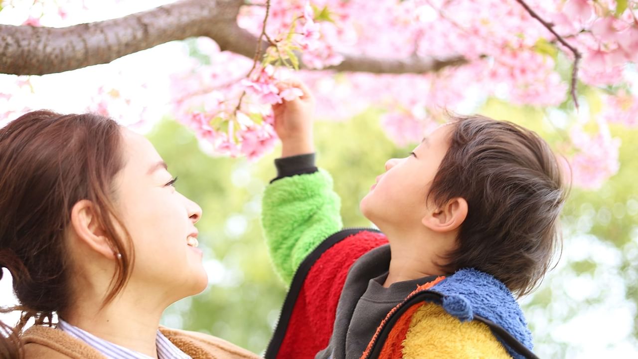 mom and son looking at spring blossoms