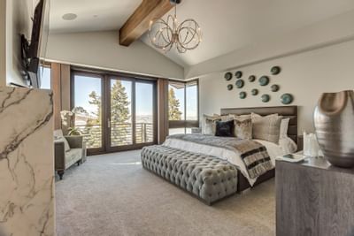 Bedroom with a king bed featuring TV & couches at Stein Eriksen Residences