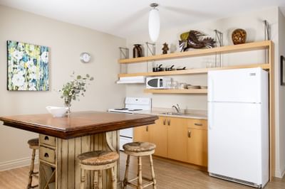 Kitchen area with pantry & dining table in Apartment 301 at Retro Suites Hotel