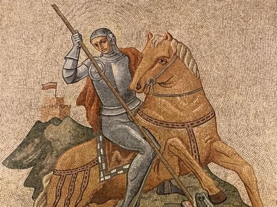 An ancient mural mosaic painting of a knight riding a horse at Bettoja Hotels Group