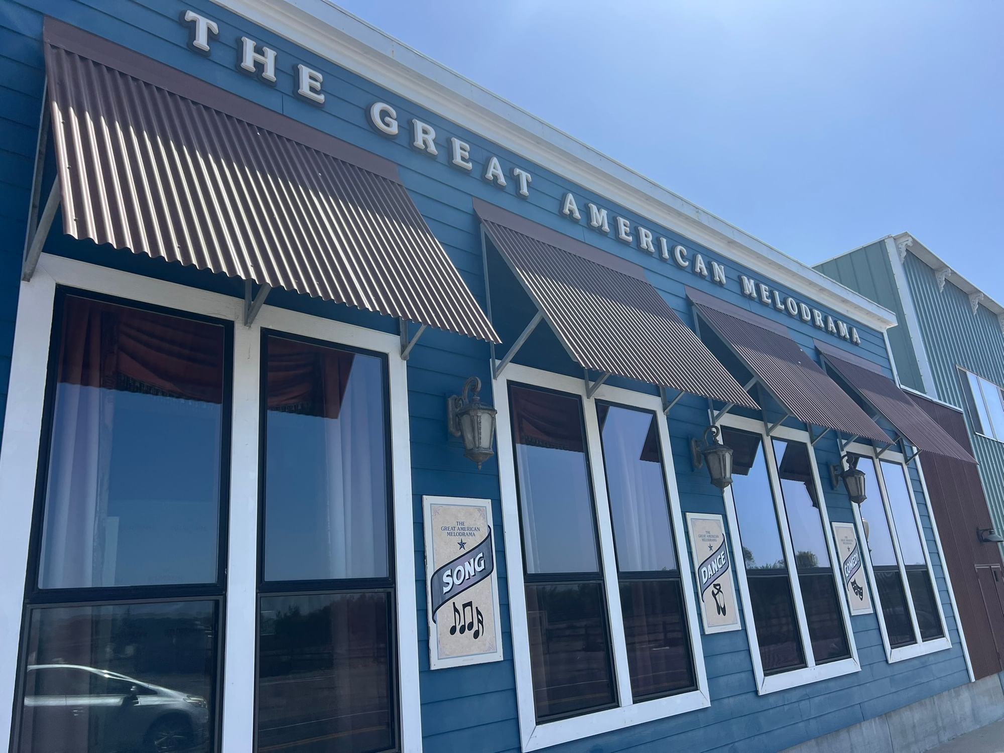 The Great American Melodrama blue exterior with red awnings