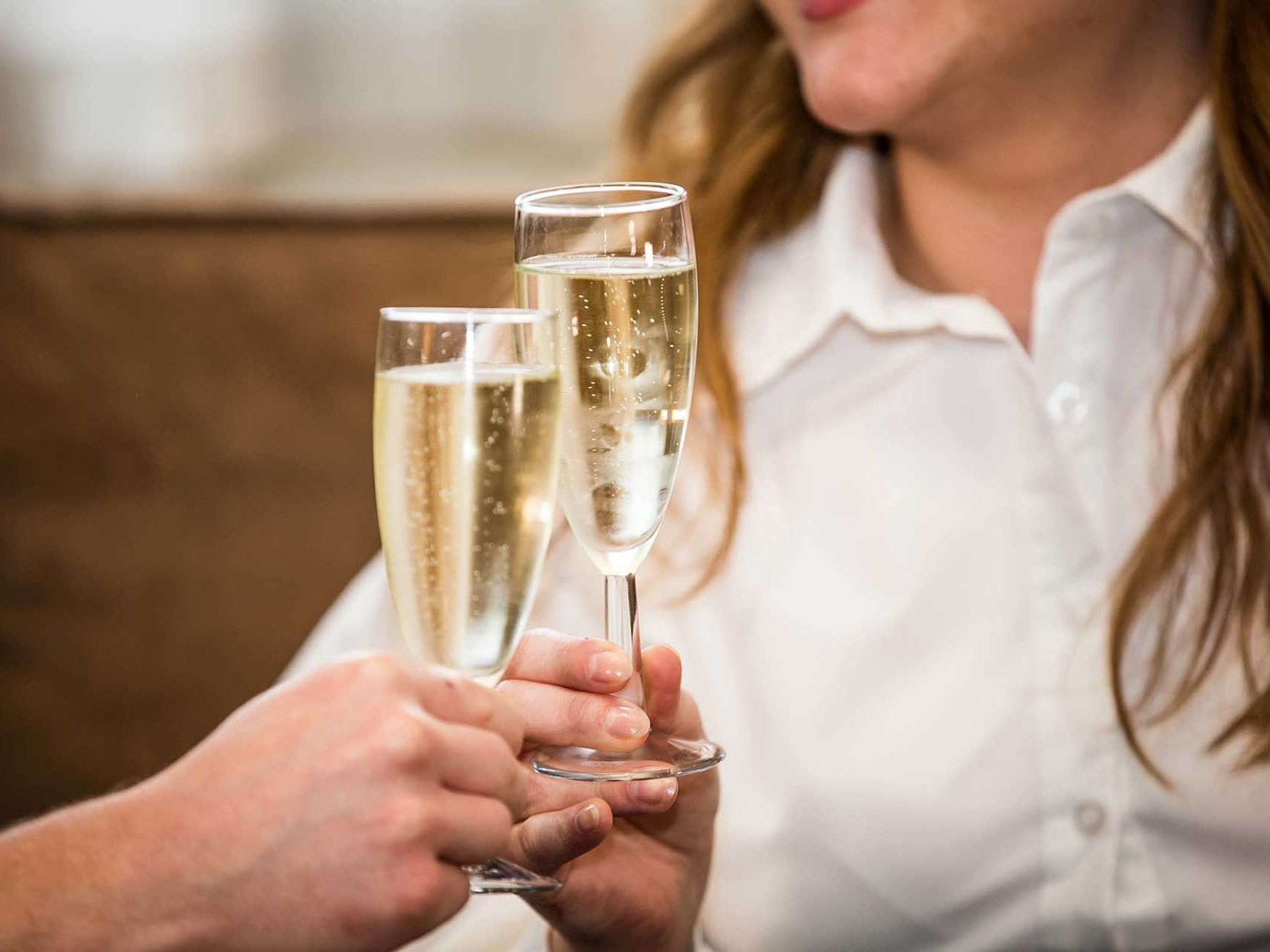 Close-up of champagne toasting at The Met Hotel Leeds
