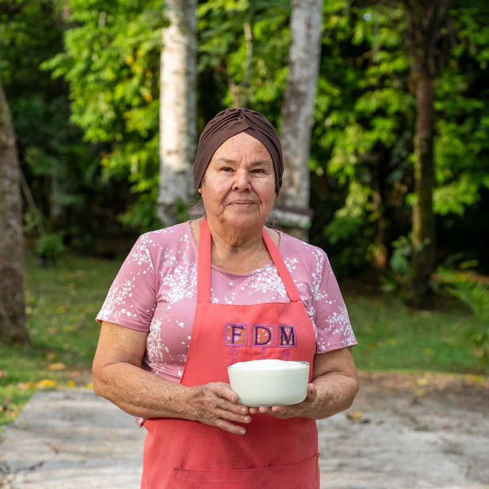 A woman posing for a picture while holding a bowl near Hideaway Rio Celeste