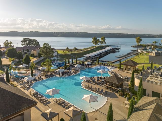 Aerial view of exterior pool featuring the lake at The Pool Bar at Shangri La Resort and Golf Club