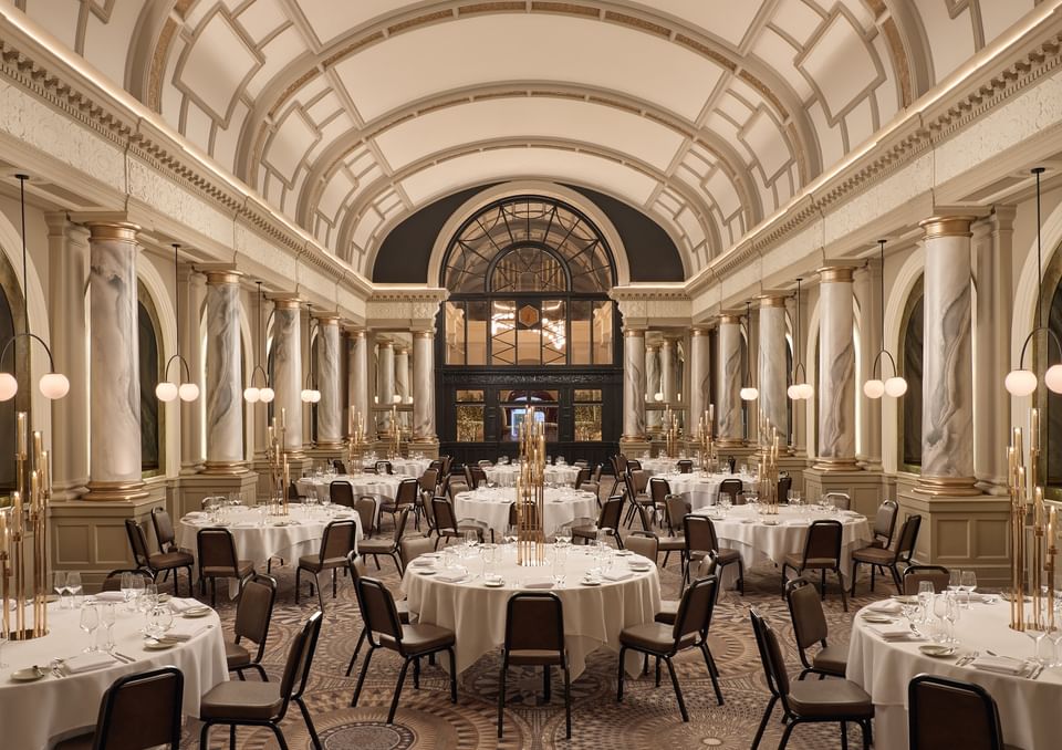 Scenic view of The Met Ballroom at The Met Hotel Leeds, England, with elegant arched ceilings and golden marble columns