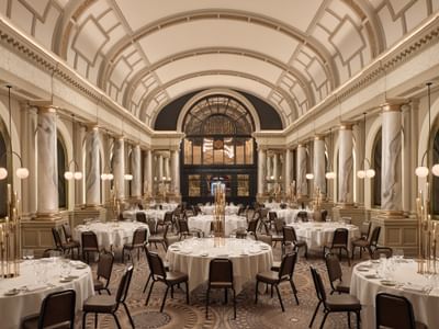Scenic view of The Met Ballroom at The Met Hotel Leeds, England, with elegant arched ceilings and golden marble columns