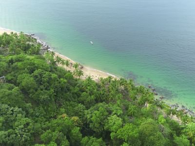 Aerial view of Maraika Beach Cottages with sea near Villa Premiere Boutique Hotel & Romantic Getaway