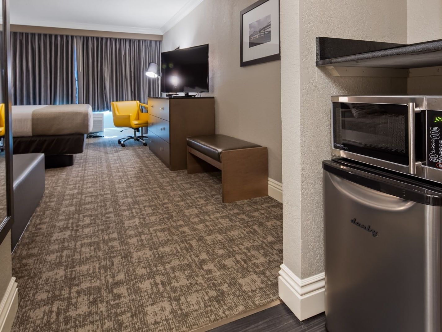 Two Double Beds featuring TV with chair & kitchenette nook in one of the Louisville hotel rooms at Cottonwood Louisville