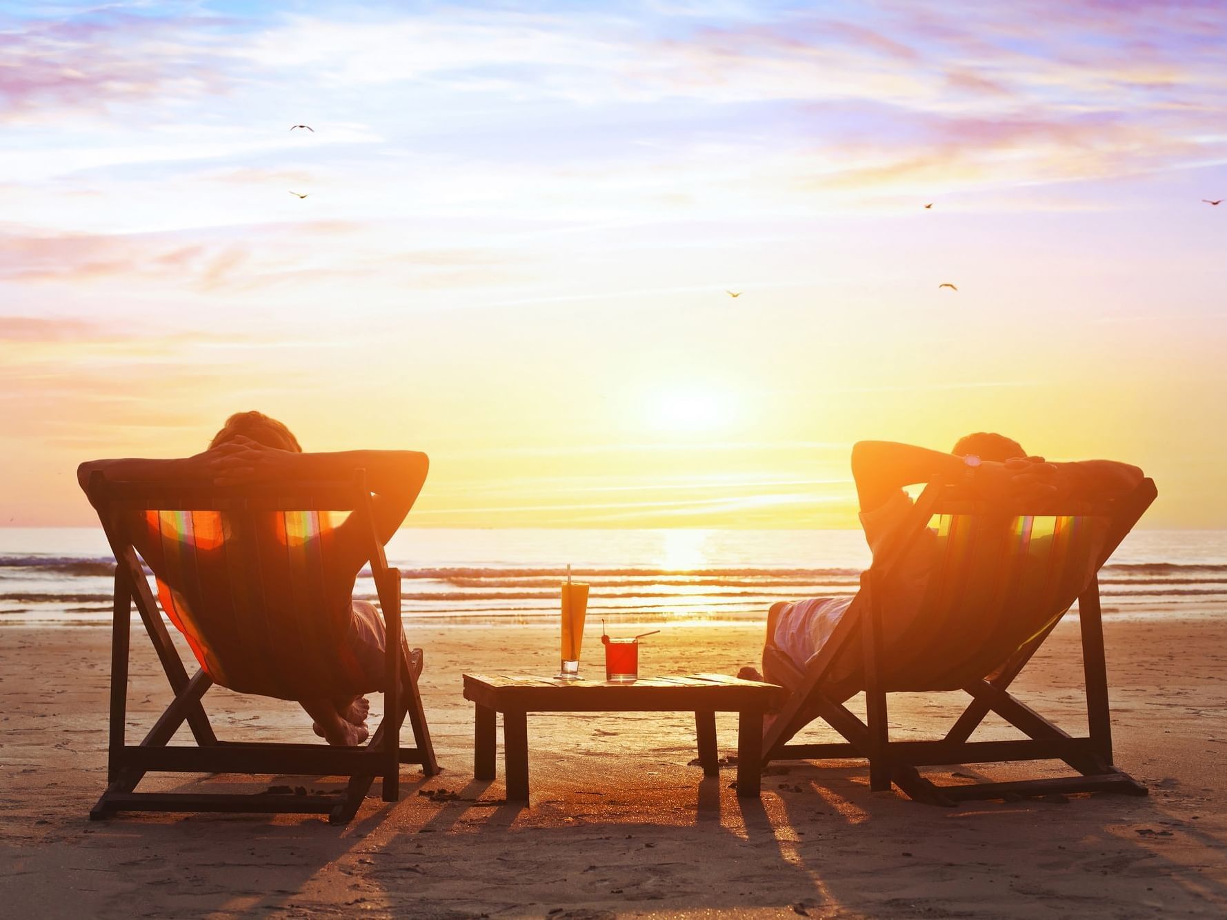 Couple on the beach during sunset near Daydream Island Resort