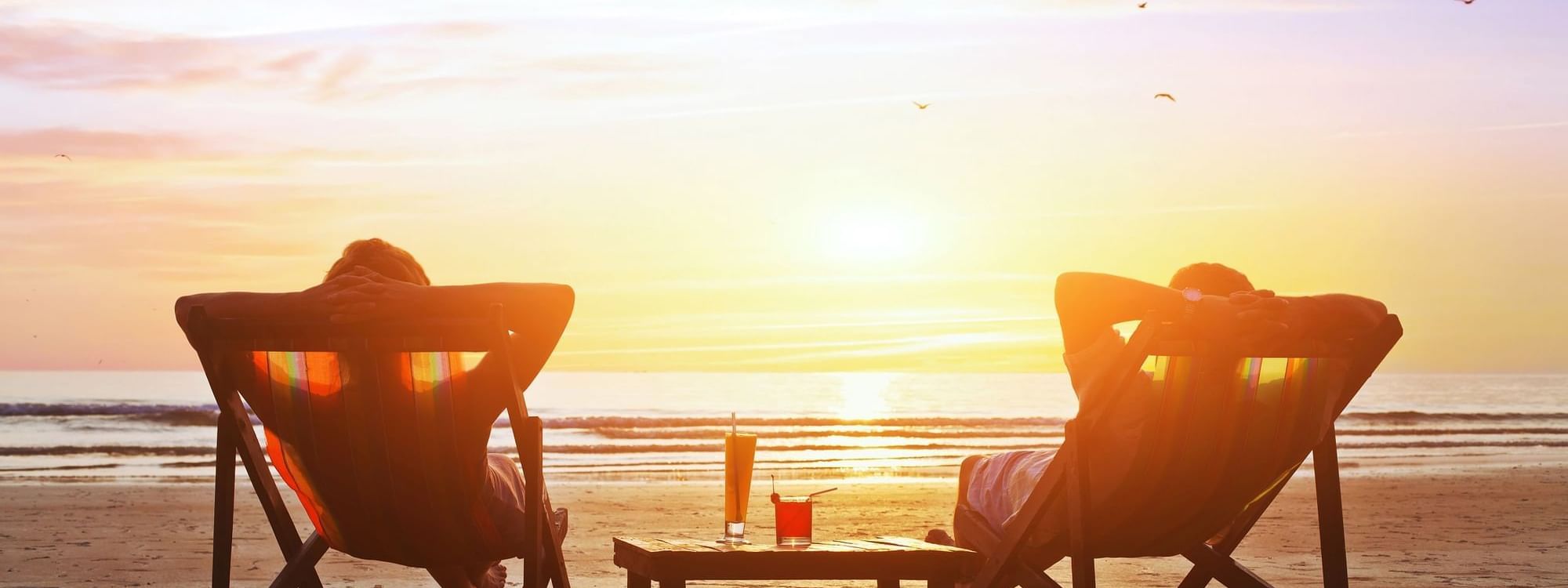 Couple on the beach during sunset near Daydream Island Resort