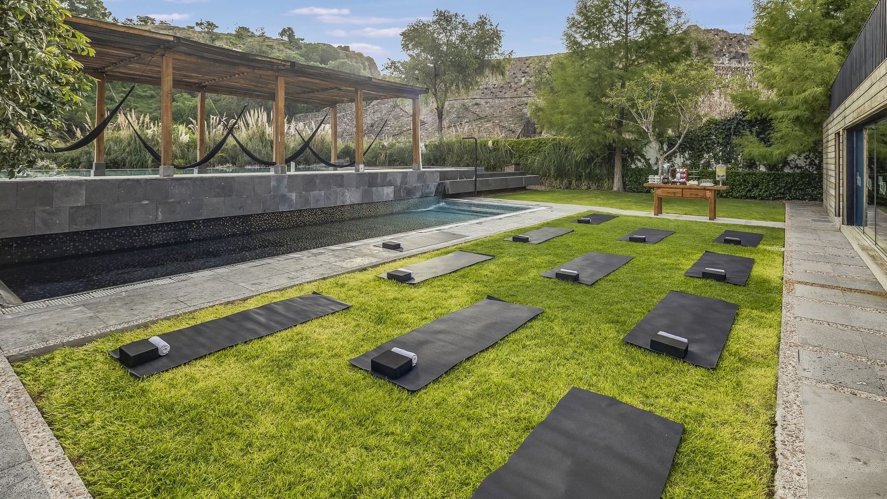 Yoga mats arranged in an outdoor backyard at Live Aqua Punta Cana