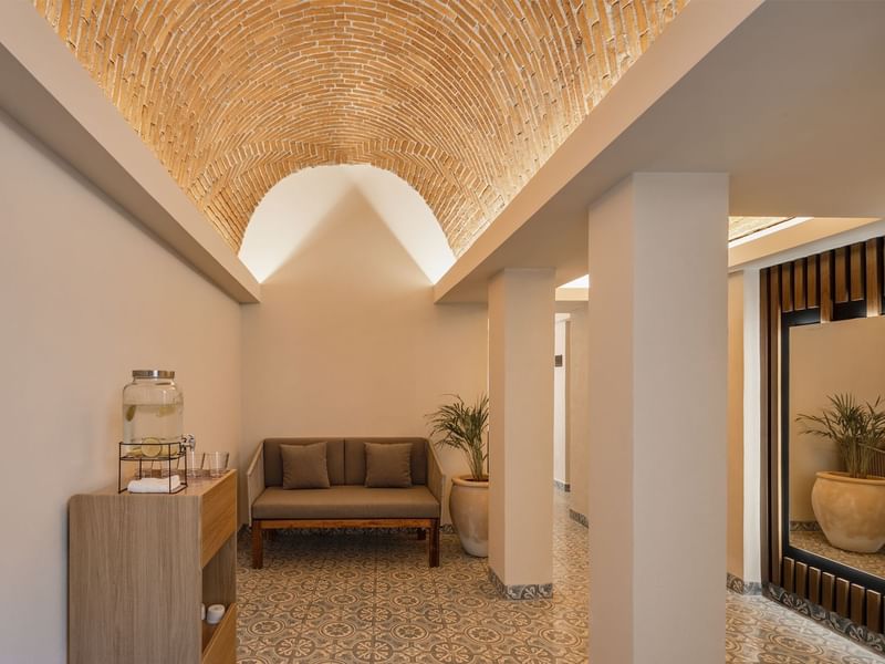 Hallway at Fiesta Americana, featuring a stunning arched brick ceiling, comfortable seating, and patterned floor tiles