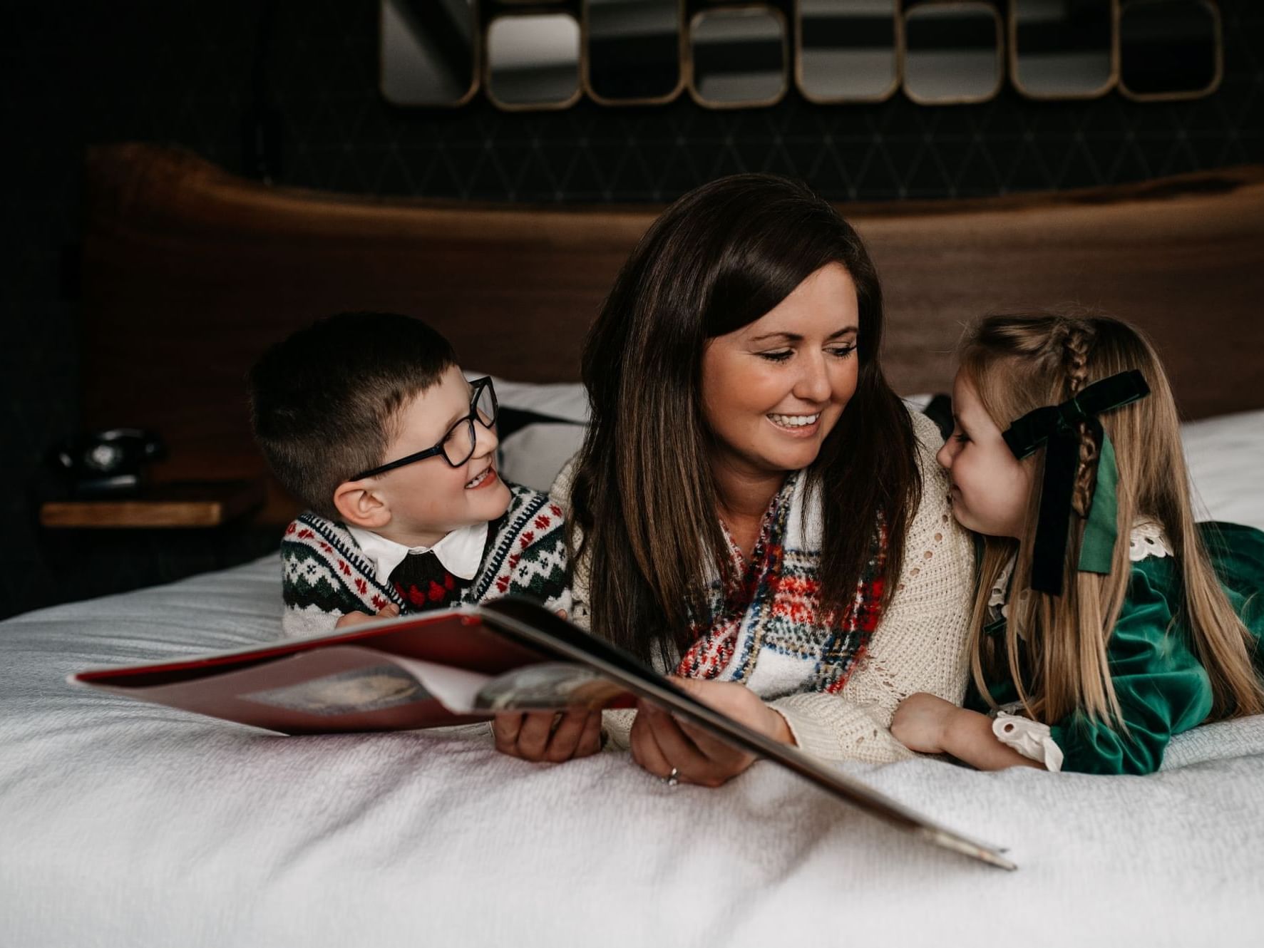 Mom reading Christmas book to the kids