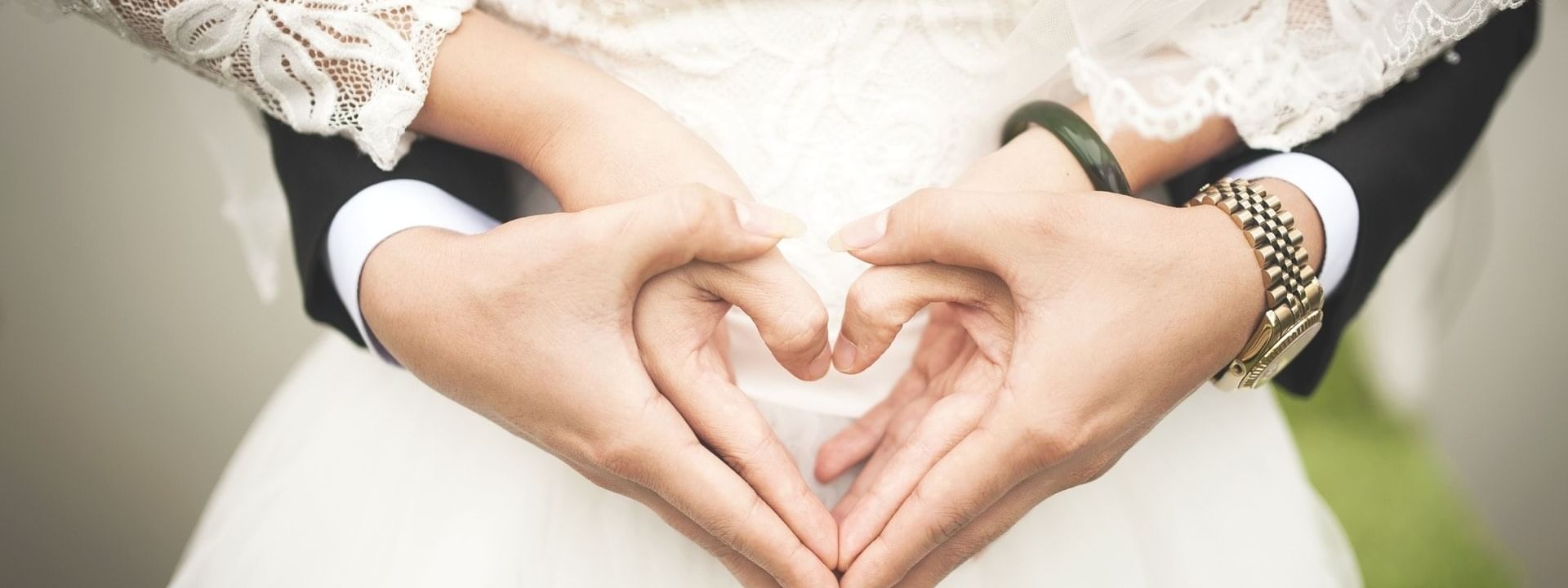 Couple hand signing a heart at Daydream Island Resort