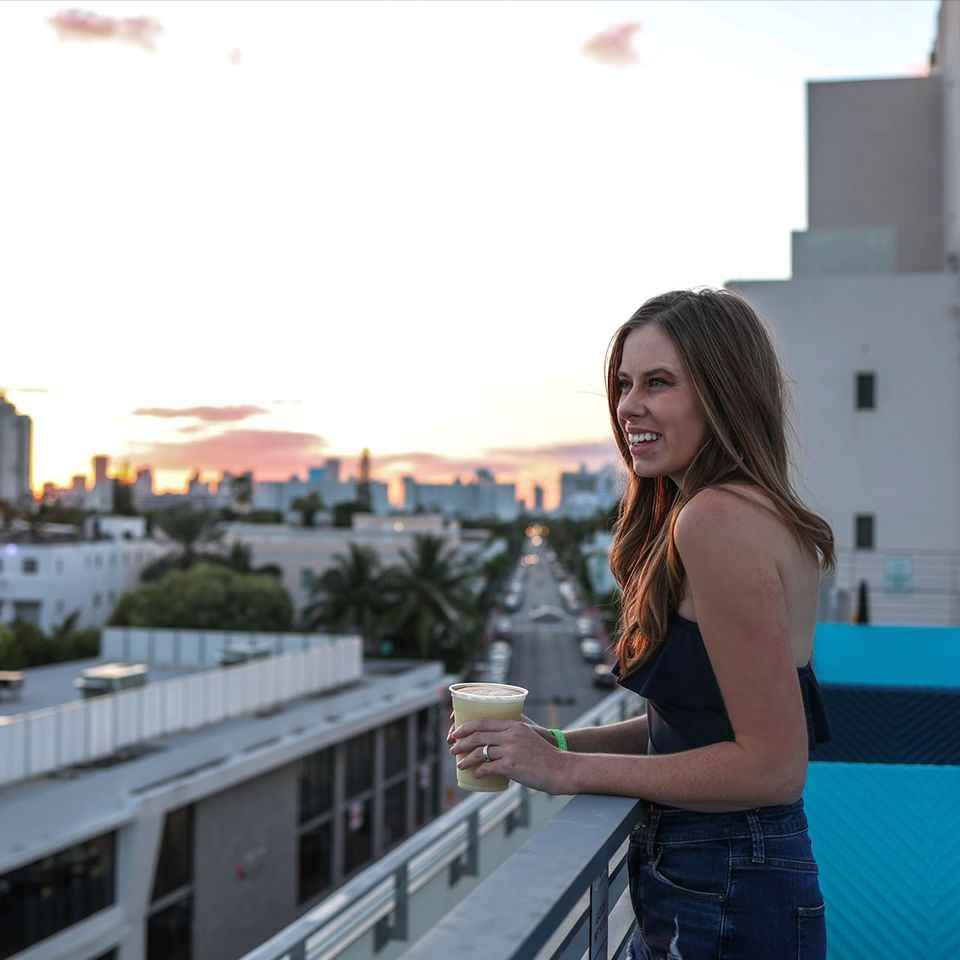 Portrait of a lady overlooking the city from the balcony at Fairwind Hotel Miami