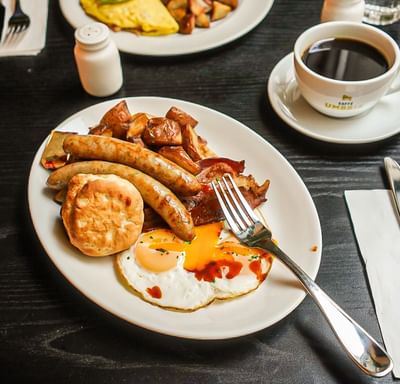The Paramount Hotel Seattle serves a delicious breakfast with eggs, sausages, bacon, potatoes, and a biscuit