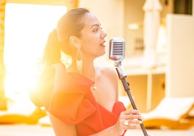 A lady singing outdoors at The Morgan Resort Spa Village