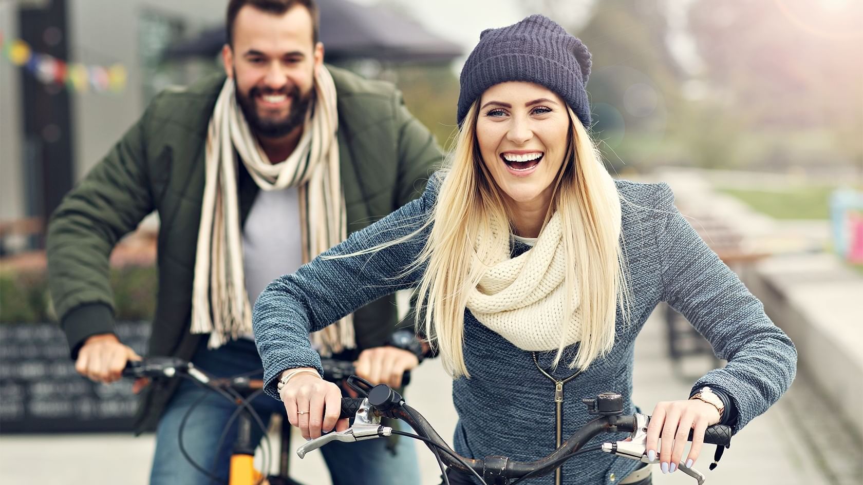 A couple riding bicycles near The Grove Hotel