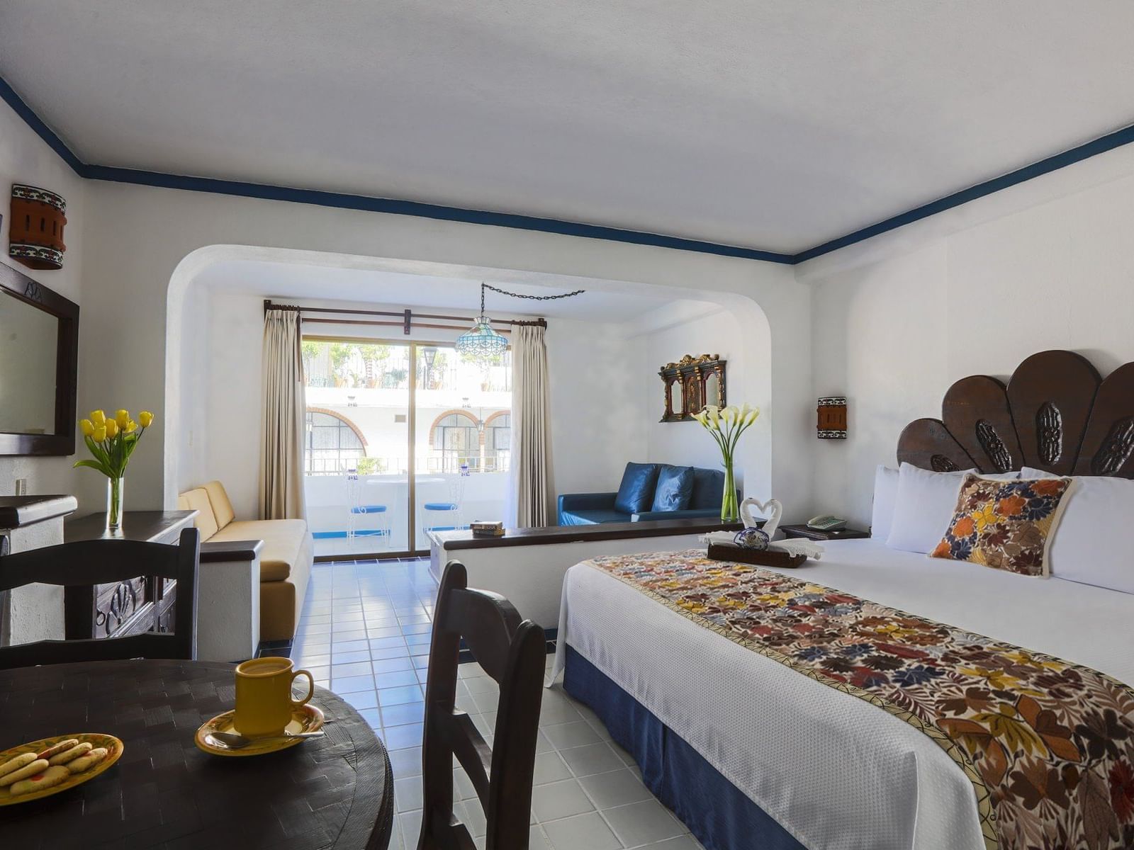 room with bed, dining table and living room area