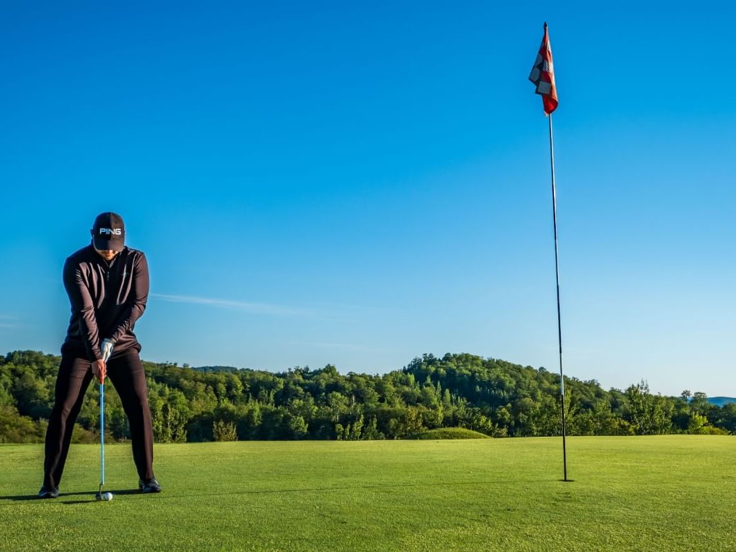 A man playing golf near Mont Gabriel Resort & Spa
