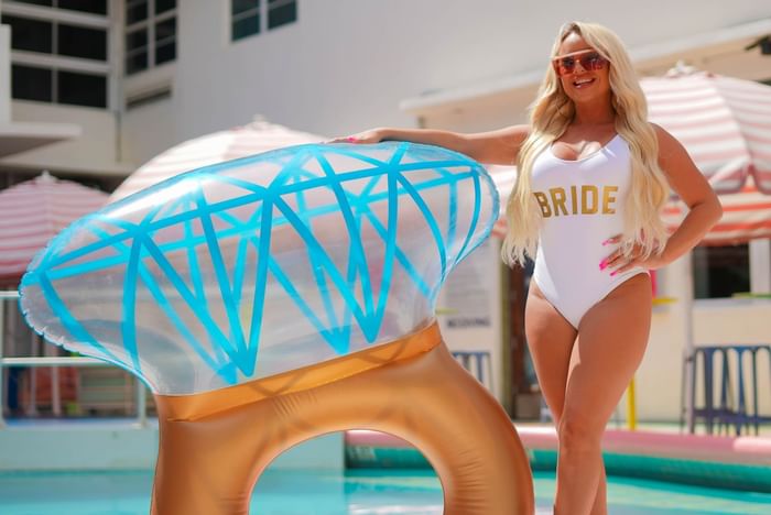 Bride posing with a pool floatie  at Clevelander South Beach