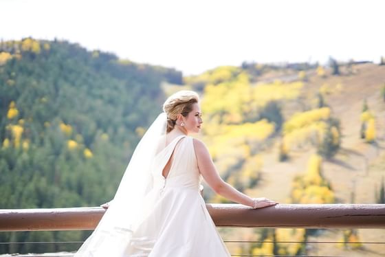 Bride posing in terrace with hill views at Stein Eriksen Lodge