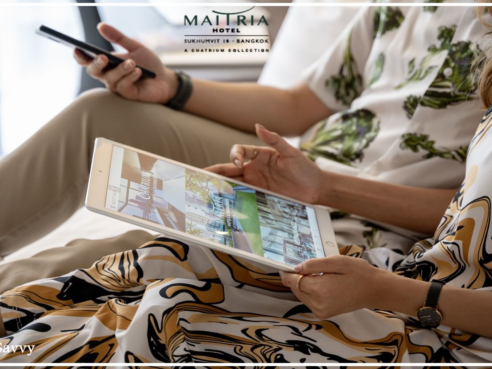 2 guests using an iPad at Maitria Hotel Sukhumvit 18