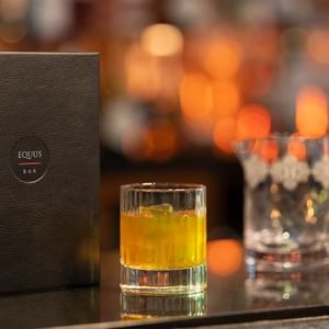 A cocktail & candle on the counter at Guoman Hotels