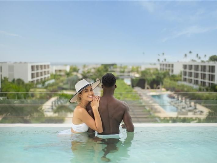 Couple overlooking the hotel from a Rooftop infinity pool at Live Aqua San Miguel de Allende