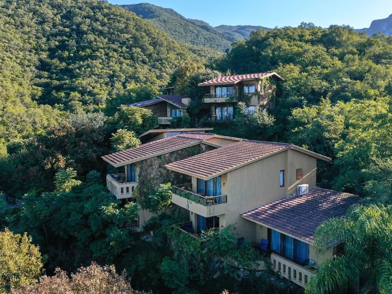 Aerial view of Gamma Hotels with trees surround and mountain view