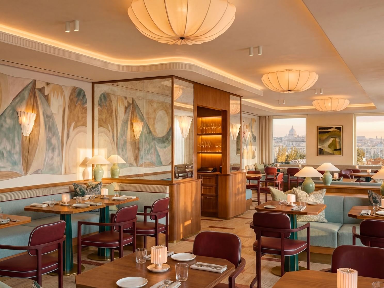 Wooden dining tables and leather chairs in Lyve Restaurant with a large window facing the skyline view at Thompson Rome